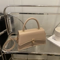 Chic beige crossbody bag with gold buckle and top handle in a minimalist style - Khaki
