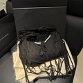 Bohemian black suede crescent bag featuring long fringe details on a soft shoulder strap - Black