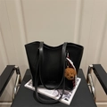 Large black minimalist tote bag with teddy bear pendant on a leather chair - With Pendant / Black