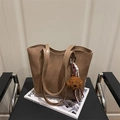 Brown leather tote bag with teddy charm on a modern designer chair for work - With Pendant / Tan