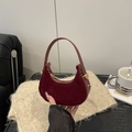 Chic burgundy suede crescent handbag with gold hardware and smooth leather handle - Red