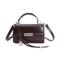 Detail of dark brown square bag showing glossy finish and silver rotating metal clasp - With Charm / Brown