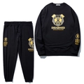 Survêtement noir avec imprimé panda doré et finitions côtelées pour un look streetwear - Sweat-shirt Et Pantalon Noirs