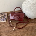 Vintage burgundy square shoulder bag with prominent buckle on a rustic wooden table - Wine Red With Pendant