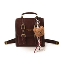 Dark brown retro backpack in matte leather featuring white contrast stitching and bear charm - With Pendant / Brown