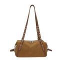 Brown leather rivet pillow bag with silver eyelets and dual zippers on white background - Brown