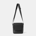 Minimalist black crossbody flap bag in textured faux leather with an adjustable strap - Black