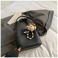 Détail d'un sac seau en cuir grainé noir avec boucle argentée et charm ours mignon - Noir Avec Pendentif