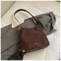 Detail of dark brown suede tote bag with gold brand lettering and fine matte texture - Brown