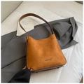 Detailed close-up of brown suede hobo bag texture with dark leather strap contrast - Brown