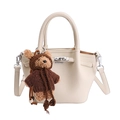 Chic beige leather tote bag with a cute bear charm and adjustable shoulder strap - White