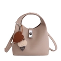 Chic beige lychee grain leather bucket bag with heart pendant and crossbody strap - Apricot