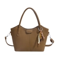Brown vintage leather bucket bag with vertical embossed stripes and beaded tassel charm - Brown
