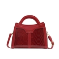 Elegant bright red patent leather handbag with snakeskin texture and golden strap hardware - Red