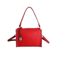 Red pebbled leather baguette bag with silver buckle and crossbody strap on white background - Red