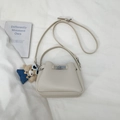 Detail of off-white lychee texture bucket bag with silver lock and cute bear charm - With Pendant / White