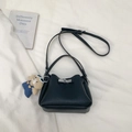 Detail of black lychee grain bucket bag with silver clasp and cute teddy bear charm - Black