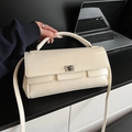Chic beige crossbody flap bag with silver buckle and glossy finish for office use - White