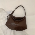 Detail of dark coffee brown tote bag with unique leather knot strap and pleated texture - Brown