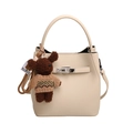 Beige lychee pattern bucket bag with silver lock and a cute plush bear charm - With Pendant / Off White