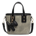 Grey canvas handbag with black leather trim and gold dog charm on white background - With Pendant / Beige & Black