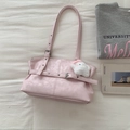 Detail of pink PU leather tote with decorative strap, metal buckle and white plush charm - Pink