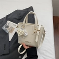 Chic cream bucket bag with elegant pearl heart charm and lace detail for women - With Pendant / Off White