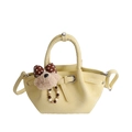 Pale yellow faux leather bucket bag with a cute bear charm and polka dot bow detail - With Charm / Yellow