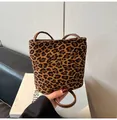 Detail of leopard print bucket bag featuring matte texture and brown leather handle - Leopard Print