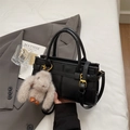 Stylish black faux leather handbag with rabbit charm and minimalist vertical stitching - With Pendant / Black