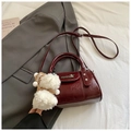 Detail of burgundy glossy leather bowling bag with plush white doll and silver buckles - With Pendant / Burgundy