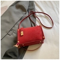 Chic red square shoulder bag with golden lock and strap on a minimalist background - Red