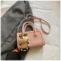 Pink faux leather crossbody handbag with embossed patterns and teddy bear charm - Pink