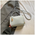 Mint green square crossbody bag with gold rivet accents and metal turn-lock closure - Blue