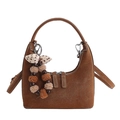 Brown suede hobo handbag with a decorative polka dot bow and colorful pompom charm - With Charm / Brown