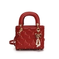 Red quilted crossbody bag with golden stars and pearl bow charm in matte finish - Red