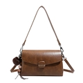 Brown leather-textured crossbody bag with a tassel charm and dual strap design - Brown