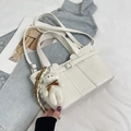 Minimalist white leather bucket bag with bear pendant and woven strap details - Off White