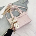 Pink minimalist bucket bag with cute teddy bear charm and adjustable shoulder strap - Pink