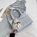 Light blue bucket bag in synthetic leather with white plush bear charm and strap - Blue