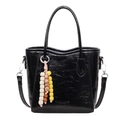 Sac seau minimaliste en cuir verni noir brillant avec texture froissée et breloque en bois - Noir