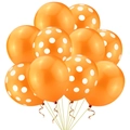 Detail view of orange latex balloons with white polka dots and gold curled ribbons - Orange