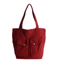 Dark red canvas tote bag featuring double front pockets and silver metal snap buttons - Red