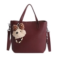 Detail view of burgundy tote bag showing textured leather surface and plush bear charm - With Pendant / Red