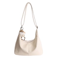 Chic cream hobo bag in wrinkled glossy leather with a cute plush charm accessory - With Charm / Off-white