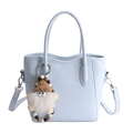 Light blue bucket handbag with cylindrical handles and a cute plush gnome charm - With Charm / Blue