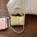 Detail of cream faux leather shoulder bag with embossed texture and cute bear charm - With Pendant / Yellow