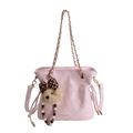 Pink quilted crossbody bucket bag with gold chain strap and cute bear keychain accessory - Pink