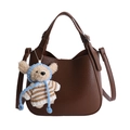 Deep brown lychee texture bucket bag with dual handles and a cute bear pendant - Brown