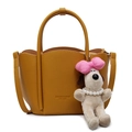 Ginger yellow bucket bag in pebble leather with plush charm and gold logo detail - Yellow